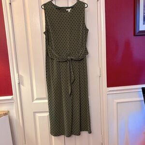 Green and black polka dot sleeveless romper with attached tie belt and back zip